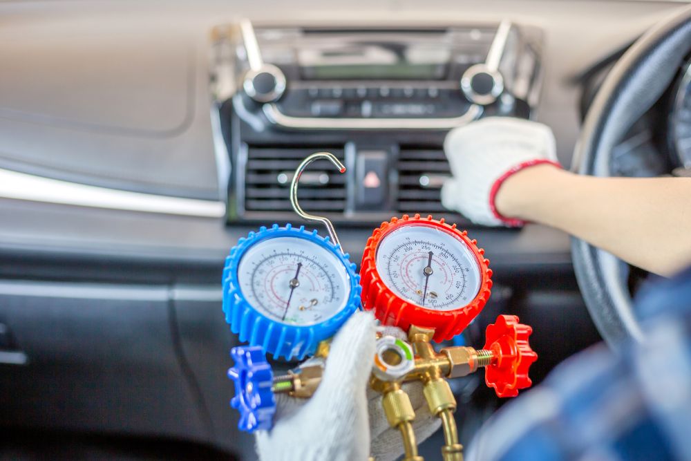 A Wilson technician checks hot and cold gauges on an automobile.