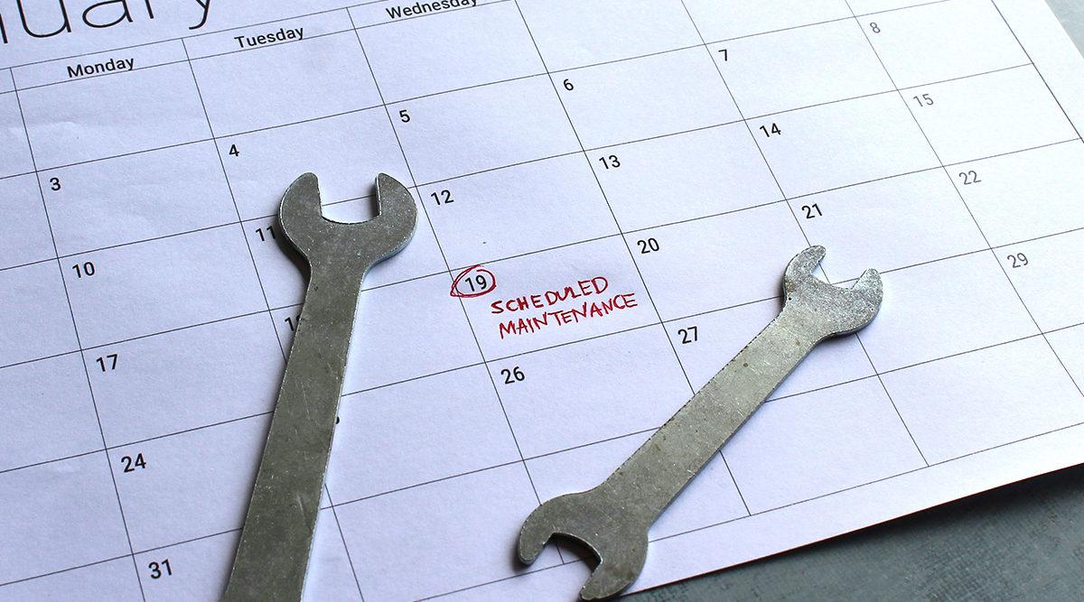 Two wrenches sit atop a paper desktop calendar of the month of January