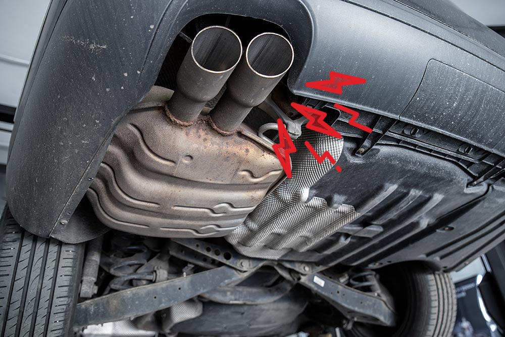 Underside of an automobile. Red "noise" elements surround the muffler, indicating that something is wrong
